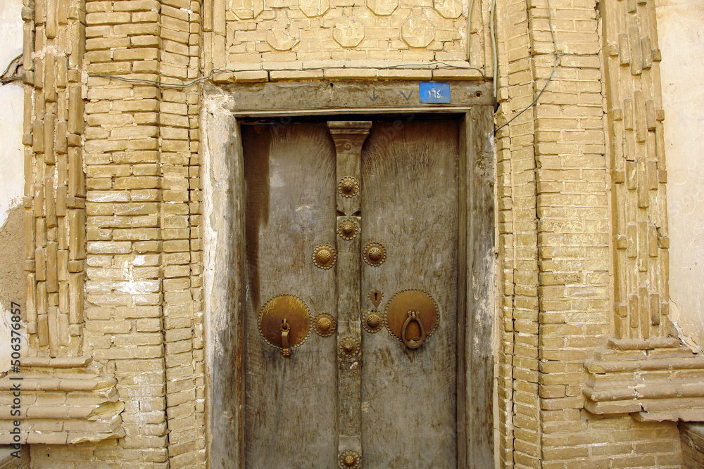 Old traditional persian door in old town district of Yazd city in Iran.