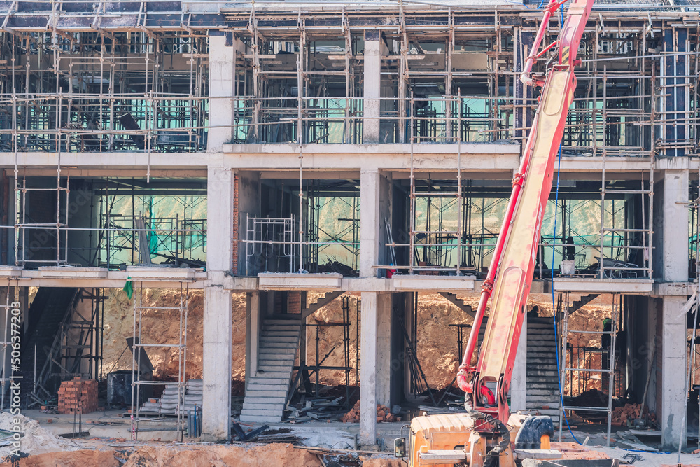 Technical modern telescopic self erection crane. Concrete multistorey new house residential