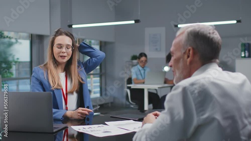 Mature entrepreneur consult with financial advisor in modern bank