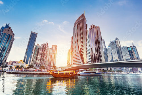 Dubai marina and tourist boat at sunset.