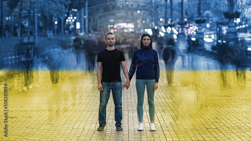 The man and woman standing on a ukrainian flag background