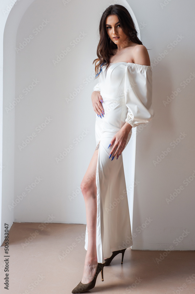 Beautiful woman wearing in luxurious long wedding dress. Concept of wedding hairstyle, makeup and accessories. Beautiful woman wearing in luxurious long wedding dress. Concept of wedding hairstyle, makeup and accessories.