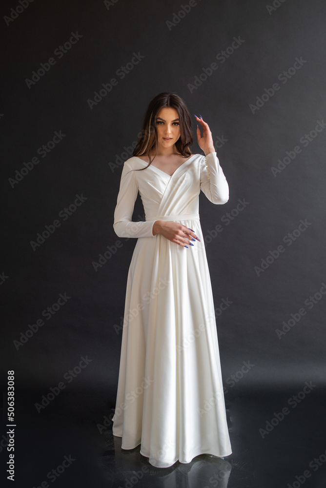 Beautiful woman wearing in luxurious long wedding dress. Concept of wedding hairstyle, makeup and accessories. Beautiful woman wearing in luxurious long wedding dress. Concept of wedding hairstyle, makeup and accessories.