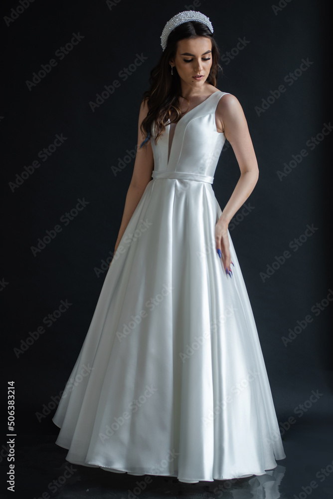 Beauty Portrait of bride wearing in wedding dress with voluminous skirt, studio photo. Young attractive bride. Smiling beautiful young bride Beauty Portrait of bride wearing in wedding dress with voluminous skirt, studio photo. Young attractive bride. Smiling beautiful young bride