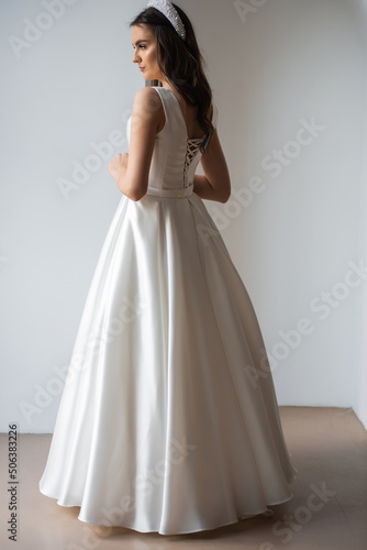 The beautiful woman posing in a wedding dress