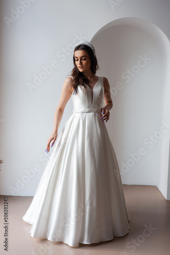 The beautiful woman posing in a wedding dress