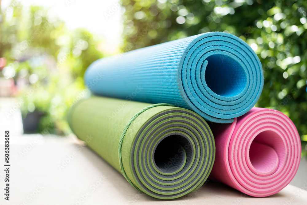 close up of colorful yoga mat on the table, sport and healthy concept close up of colorful yoga mat on the table, sport and healthy concept