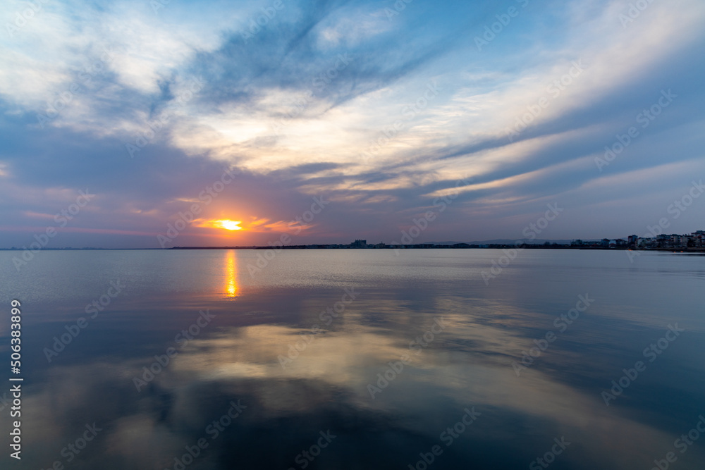 View of the reflection in the Black Sea against the background of the sky and sunset