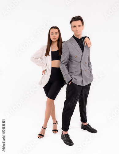 Caucasian loving couple in the studio on a white background in stylish clothes