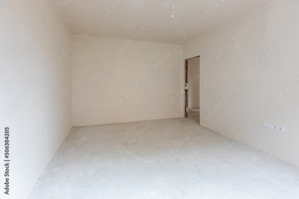 New empty room under construction. Plaster walls. New home. Concrete walls. Interior renovation. New empty room under construction. Plaster walls. New home. Concrete walls. Interior renovation.