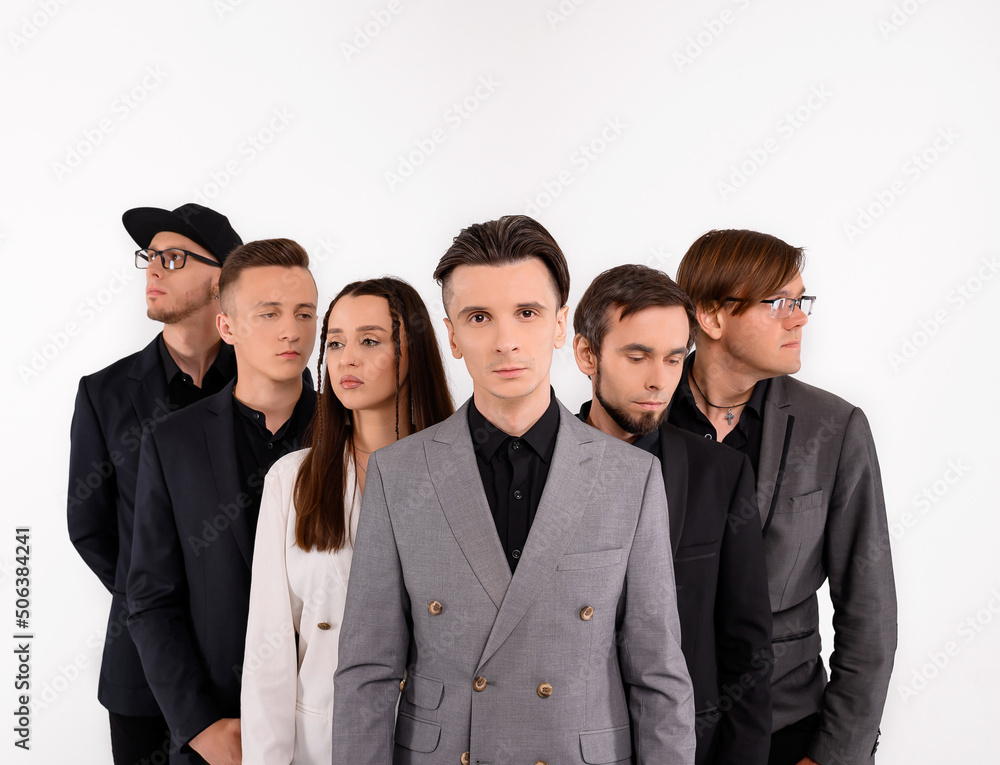 Six caucasian young people posing on a white background in the studio. Medium plan Six caucasian young people posing on a white background in the studio. Medium plan