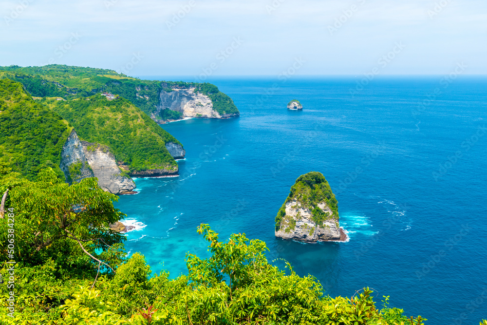 Paluang cliff above beautiful blue waters near Kelingking Beach on Nusa Penida island.