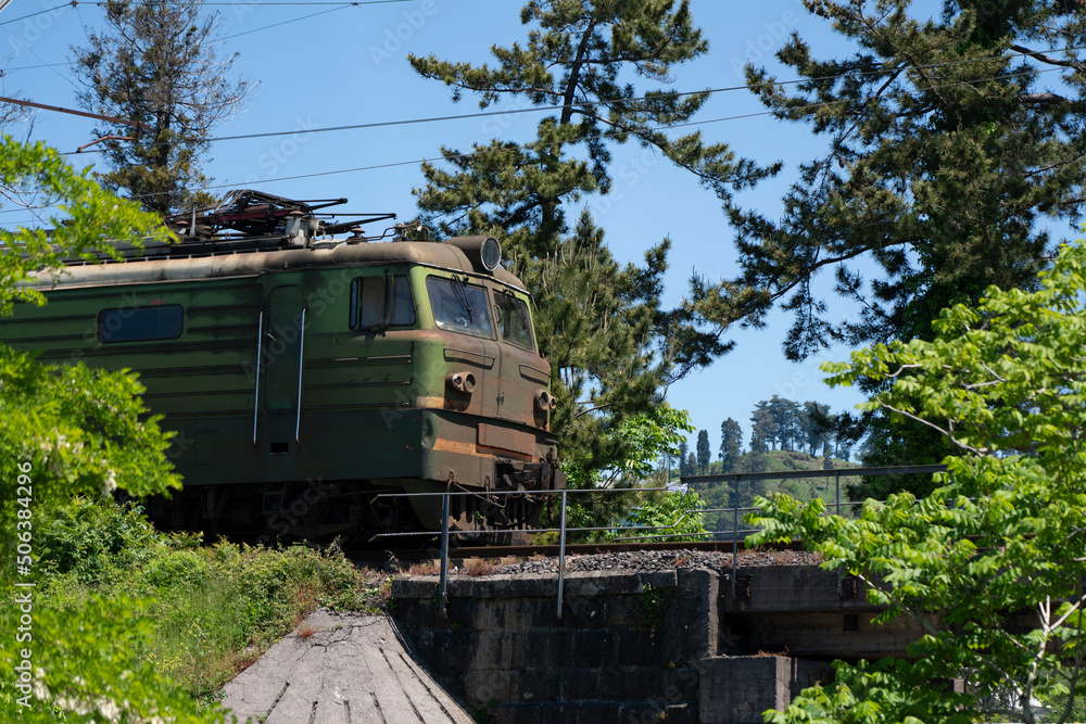 Naklejka premium old train rides through the park
