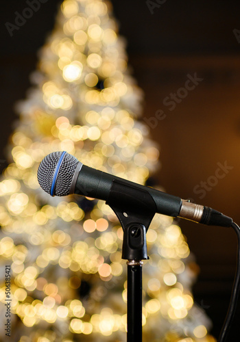 Microphone on the background of the Christmas tree. High quality photo. Close up