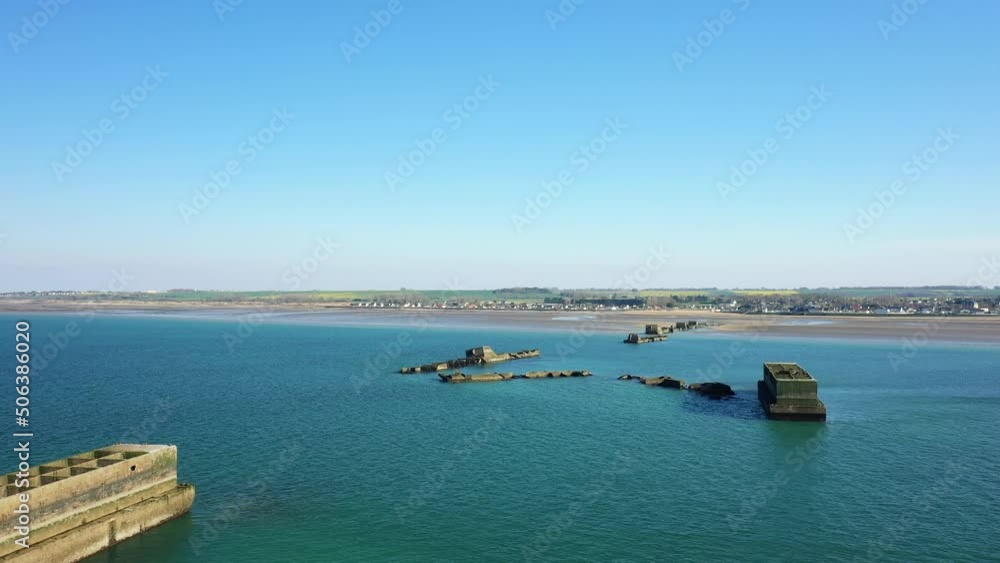 The artificial harbor in the Channel Sea in Europe, France, Normandy, towards Arromanches, Asnelles, in spring, on a sunny day.