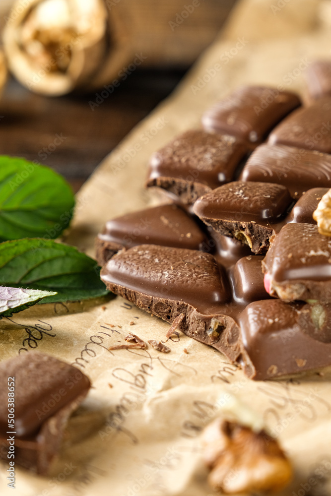 scary photo of chocolate, ugly photo of milk chocolate, slices of chocolate on white background, mint and raspberry leaves on white background, photo of chocolate for magazine with space for text scary photo of chocolate, ugly photo of milk chocolate, slices of chocolate on white background, mint and raspberry leaves on white background, photo of chocolate for magazine with space for text