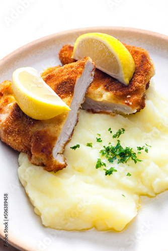 chicken schnitzel with mashed potatoes and lemon