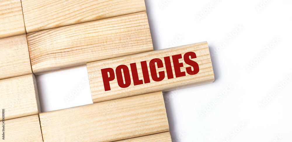 On a light background, wooden blocks with the text POLICIES. Close-up top view. On a light background, wooden blocks with the text POLICIES. Close-up top view.