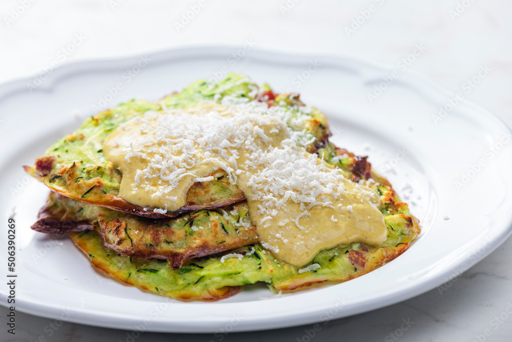 zucchini cakes with mustard sauce and parmesan cheese