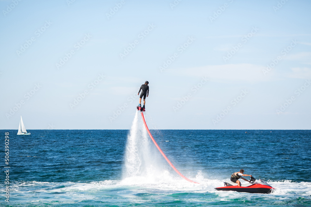 Obraz premium Silhouette of a fly board rider at sea