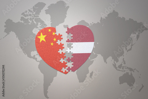 Photography puzzle heart with the national flag of china and latvia on a world map background