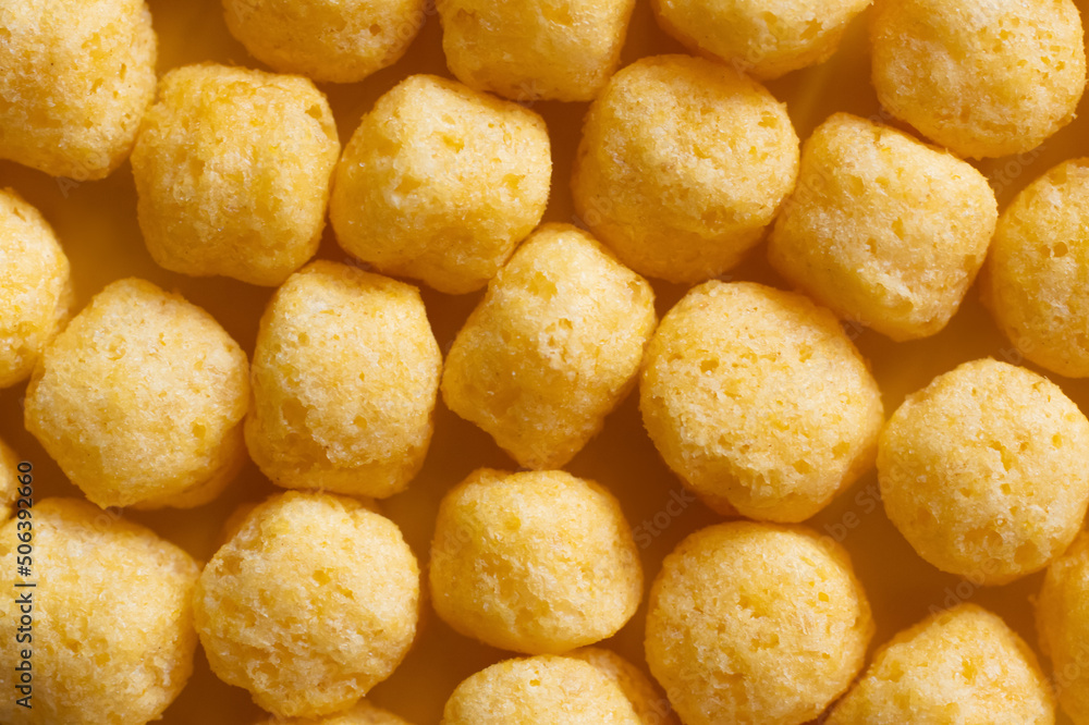 top view of puffed, delicious and salty cheese pops top view of puffed, delicious and salty cheese pops