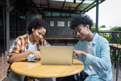 Student Life. Two students in school and working on laptop, checking social media. Teen student in university Use laptop and Tablet.