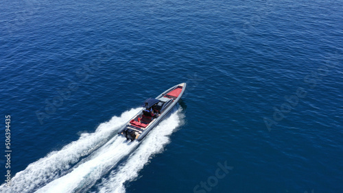 Aerial drone photo of inflatable rigid power boat cruising in high speed in Aegean deep blue sea bay, Greece
