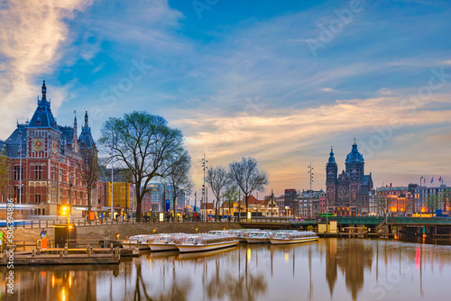 Amsterdam Netherlands, night city skyline at Amsterdam Central Station and Basilica of Saint Nicholas