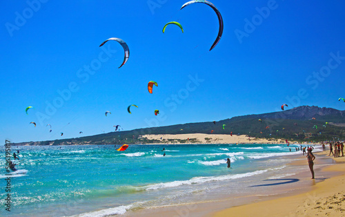 Tarifa, (Costa de la luz, Playa de Bolonia), Spain - June, 18. 2016: Beautiful atlantic ocean kite surfers lagoon, natural sand beach, hills, blue sky