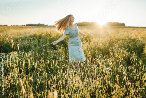 Woman dance in the field on sunset.
