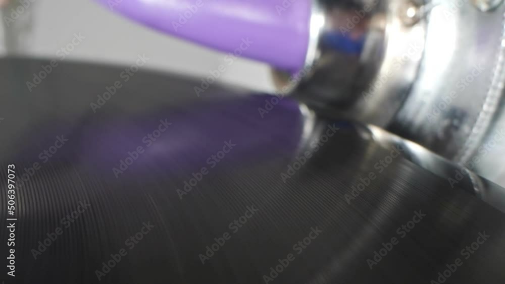 extreme close-up, detailed. An old phonograph needle falls off a spinning vinyl record. extreme close-up, detailed. An old phonograph needle falls off a spinning vinyl record.