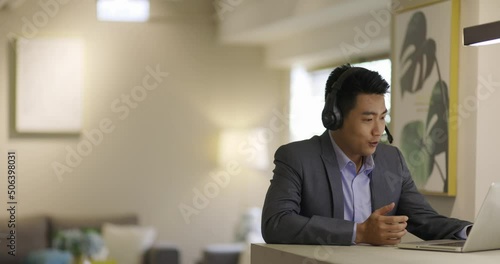 An asian chinese man white collar worker talking to the camera video calling video conference with his business partners photo