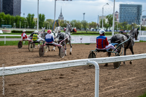 test of trotting horses on the racetrack at the hippodrome photo