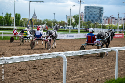test of trotting horses on the racetrack at the hippodrome photo