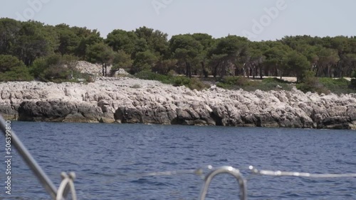 Coastline of an island in Croatia, view from a yacht. High quality FullHD footage