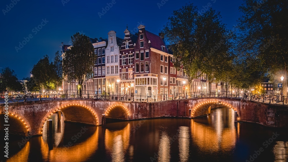 Amsterdam, Netherlands bridges and canals at twilight.