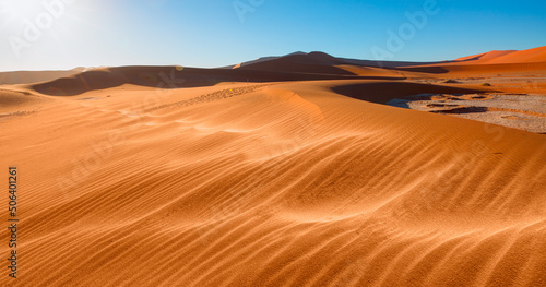 Panoramic view of orange sand dune desert with clear blue sky at Namib desert - Namibia