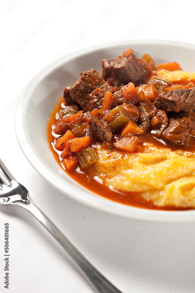 Polenta and beef stew on a plate. High quality photo. Polenta and beef stew on a plate. High quality photo.