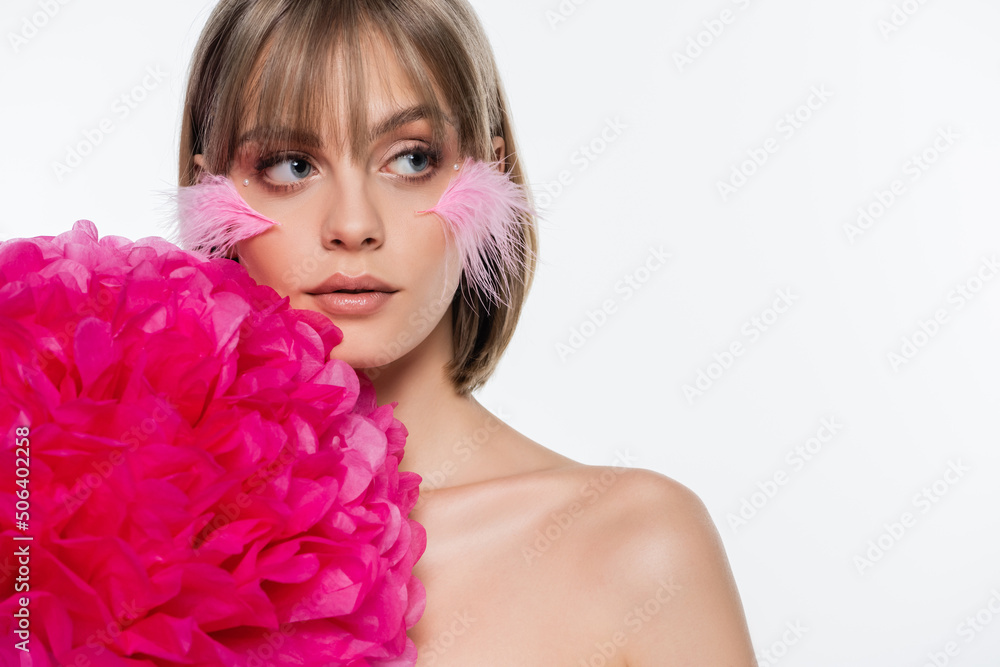 pretty woman with decorative elements in makeup and pink feathers on cheeks near bright flower isolated on white pretty woman with decorative elements in makeup and pink feathers on cheeks near bright flower isolated on white