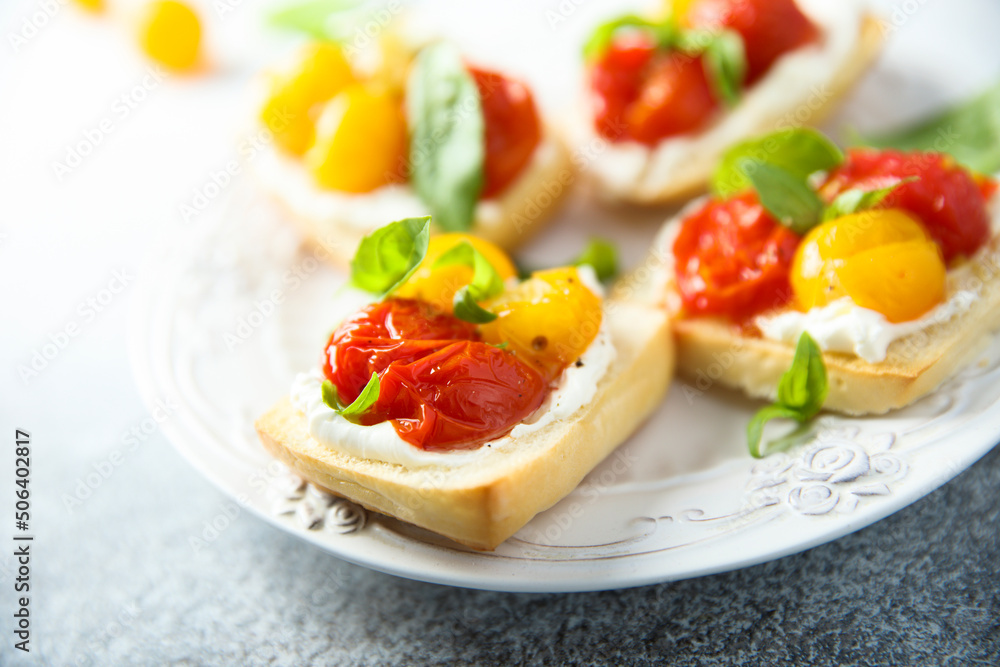 Tomato crostini with cream cheese and fresh basil Tomato crostini with cream cheese and fresh basil