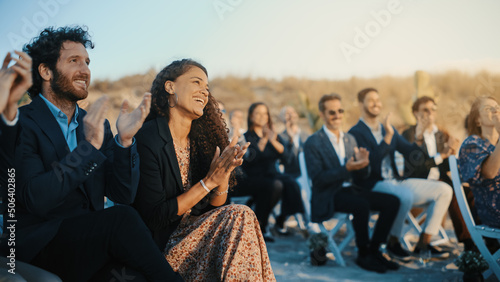 Canvas Print Excited Guests Sitting in an Outdoors Venue and Clapping Hands
