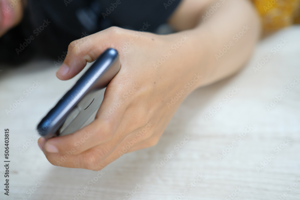 Close-up of a person's hand holding a mobile phone