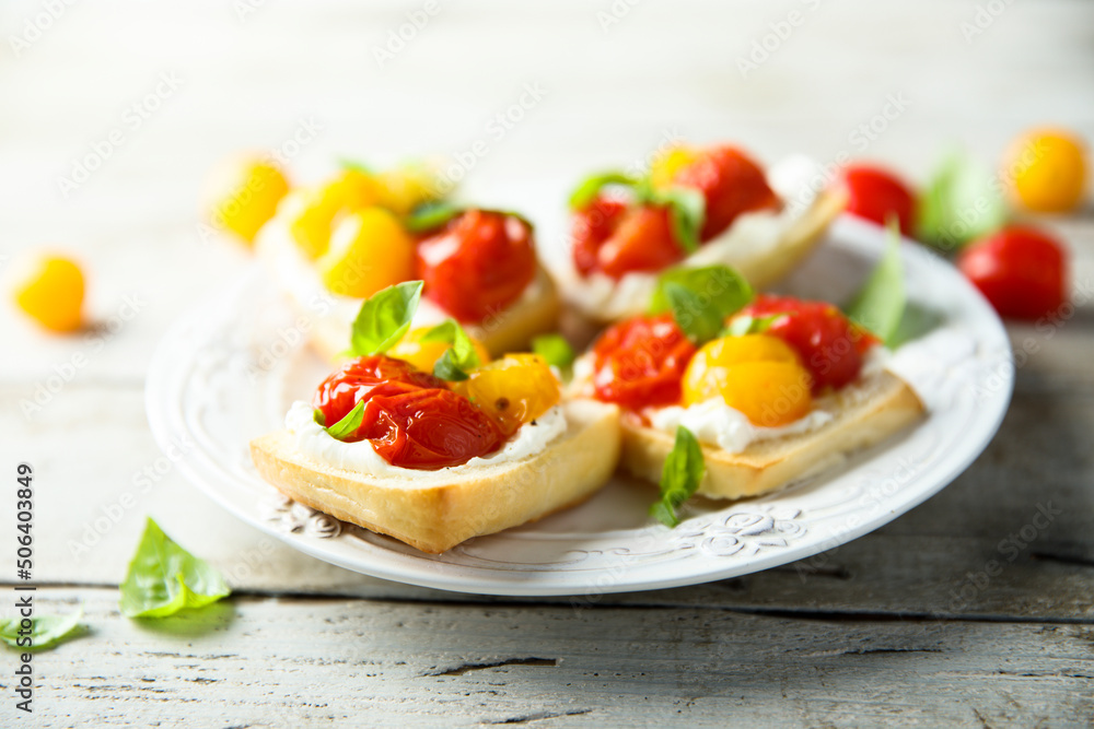 Tomato crostini with cream cheese and fresh basil Tomato crostini with cream cheese and fresh basil