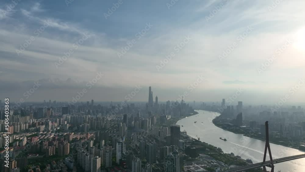 Huangpu river and industry area with Lujiazui downtown in background. Drone aerial view footage. Business, industry and travel concept b-roll footage in asian city. High angle view of Shanghai Huangpu river and industry area with Lujiazui downtown in background. Drone aerial view footage. Business, industry and travel concept b-roll footage in asian city. High angle view of Shanghai