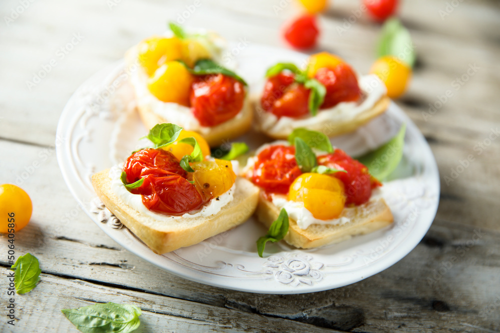 Tomato crostini with cream cheese and fresh basil Tomato crostini with cream cheese and fresh basil