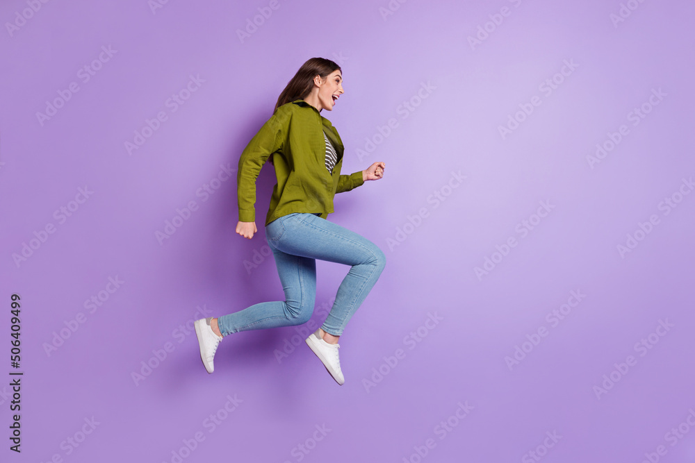 Full length profile side photo of cheerful overjoyed young lady sportive running isolated on violet color background