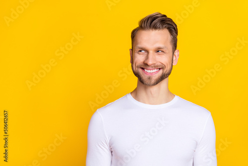 Portrait of glad funky person toothy smile look interested empty space isolated on yellow color background