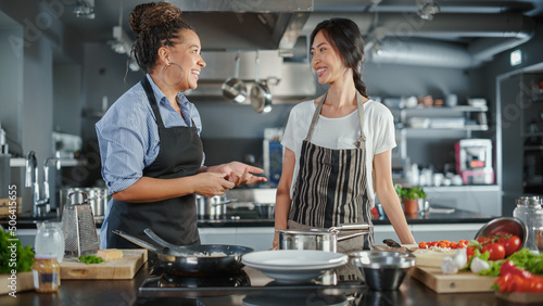TV Cooking Show Kitchen with Two Master Chefs. Asian and Black Female Hosts Talk. Professionals Teach How to Cook Food, Taste Delicious Dish. Online Video Class Courses. Healthy Dish Recipe Prepare