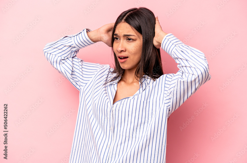 Young hispanic woman isolated on pink background screaming, very excited, passionate, satisfied with something. Young hispanic woman isolated on pink background screaming, very excited, passionate, satisfied with something.